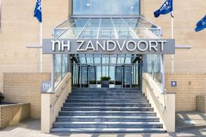a staircase leading to a building with a sign that reads mz zamboren at NH Zandvoort Hotel in Zandvoort