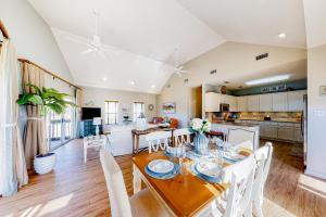 a dining room and kitchen with a table and chairs at Bella By the Sea in Dauphin Island
