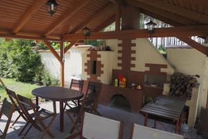 a patio with a brick fireplace and a table and chairs at WIlla Maksymilian Bed and Breakfast in Bydgoszcz