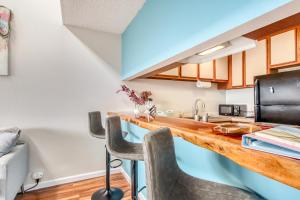 a kitchen with a wooden counter top and chairs at Kailua Bay Resort 5307 in Kailua-Kona