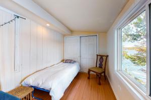 a small bedroom with a bed and a window at The Lake House in Plymouth
