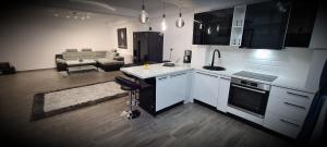 cocina con electrodomésticos blancos y sala de estar. en D3 ASP - VIVO Mall en Floreşti