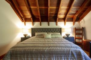 una camera da letto con un letto grande con due lampade di Villa Mimosa Hot Tub Fire Table BBQ Walk to River Dog Friendly a Guerneville