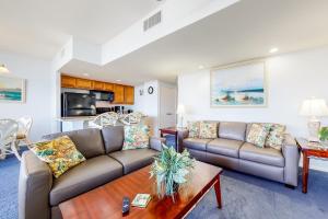 a living room with two couches and a table at Sunchase IV in South Padre Island