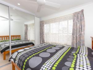 a bedroom with two beds and a window at Wayila in Hawks Nest