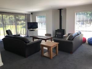 a living room with two couches and a fireplace at 4 Bedroom on North West Arch - Free Wifi in Twizel