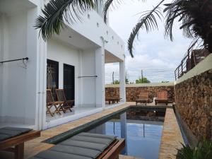 a villa with a swimming pool and a patio at Spear Villa in Bumbang