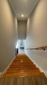 a long hallway with a wooden floor and white walls at Luxury House Cottage - Foley in Foley