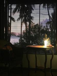 a table with a candle on it in front of a window at Jasmine & Tea House in Mae Nam