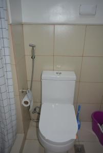 a bathroom with a white toilet and a shower at Paranaque SM-Sucat Field Res. Bldg 5, 2/F, 2BR with Balcony in Manila
