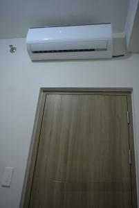 a ceiling with a heater and a wooden cabinet at Paranaque SM-Sucat Field Res. Bldg 5, 2/F, 2BR with Balcony in Manila