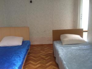 ヴァルダネにあるTur Service Guest Houseのベッド2台が隣同士に設置された部屋です。