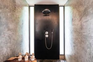 a bathroom with a shower, toilet, and sink at TreeHouse Villas - Adults Only - SHA Extra Plus in Ko Yao Noi
