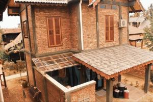 a brick house with a roof on top of it at The Daun Resort Langkawi in Pantai Cenang
