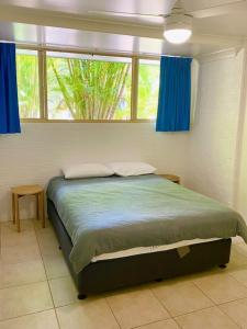 
a bedroom with a bed and a window at Orchid Beach Apartments in Fraser Island
