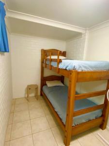 
a bunk bed in a small room at Orchid Beach Apartments in Fraser Island
