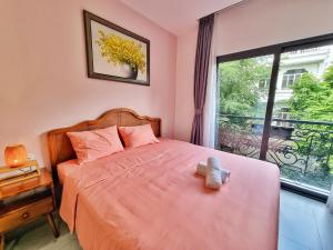 a bedroom with a bed with a large window at Mai Home - Apartment & Homestay in Ho Chi Minh City
