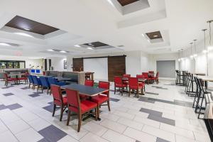 a dining room with tables and chairs and a chalkboard at Holiday Inn Express & Suites Austin NW – Lakeway, an IHG Hotel in Lakeway
