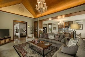 a living room with a couch and a table at Plataran Borobudur in Borobudur