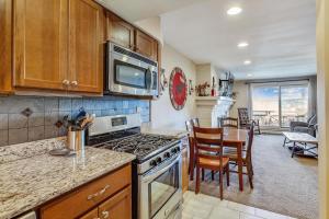 a kitchen with a stove and a dining room at Sunrise Timberline I7 in Killington
