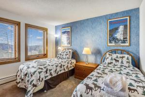 a bedroom with two beds and two windows at Sunrise Timberline I7 in Killington +33 photos