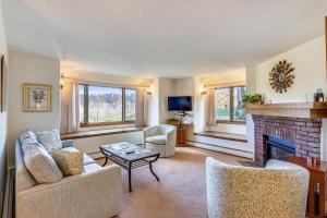 a living room with a couch and a fireplace at Sunrise Cambridge 101 in South Sherburne