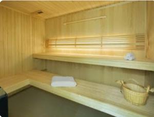 a bathroom with a shelf with a towel and a basket at Canal Views Studio Apartment in Dubai