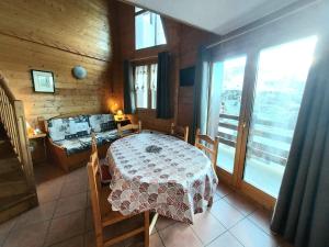 a dining room with a table and some windows at Appartement La Plagne-Tarentaise, 2 pièces, 6 personnes - FR-1-351-151 in La Plagne Tarentaise