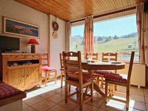 a dining room with a table and chairs and a window at Appartement Chamrousse, 2 pièces, 6 personnes - FR-1-549-11 in Chamrousse