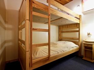 a bunk bed room with two bunk beds in it at Appartement Chamrousse, 2 pièces, 6 personnes - FR-1-549-11 in Chamrousse