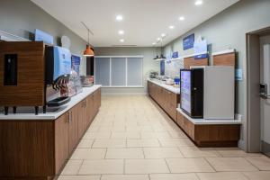 a large kitchen with wooden cabinets and refrigerators at Holiday Inn Express & Suites Rockport - Bay View by IHG in Rockport