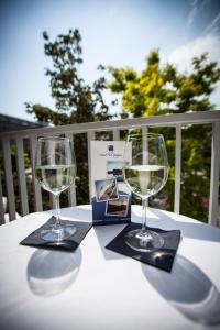 dos copas de vino sentadas sobre una mesa en Hotel Park Spiaggia, en Grado
