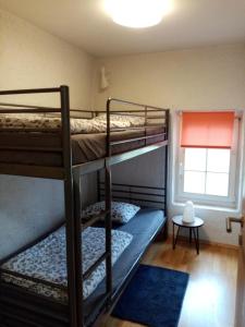 two bunk beds in a room with a window at Turm Hämelmaous in Echternach