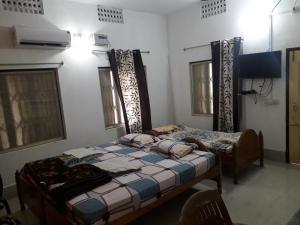 Letto o letti in una camera di Sudha Kutir Puri