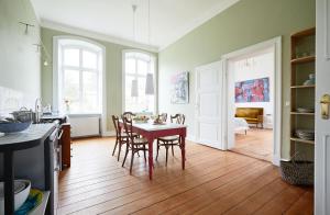 a kitchen and dining room with a table and chairs at Gut Pohnstorf in Alt Sührkow