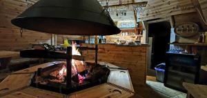 a kitchen with a stove with a fire in it at Pod Bukovkou in Petrov nad Desnou
