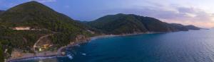 an aerial view of a beach on a mountain at Kechria Bay Villas in Skiathos