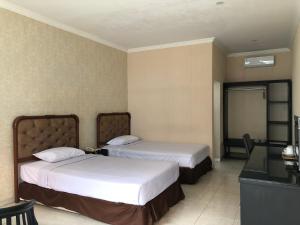 Postel nebo postele na pokoji v ubytování Hotel Sinar 3