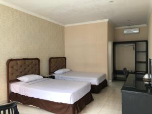 Postel nebo postele na pokoji v ubytování Hotel Sinar 3 + 12 fotografií