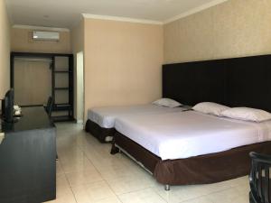 Postel nebo postele na pokoji v ubytování Hotel Sinar 3