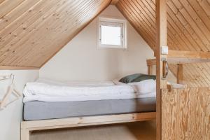 a bed in the attic of a tiny house at Skrea Camping in Falkenberg