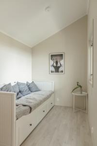 a white bedroom with a bed in a white room at Skrea Camping in Falkenberg