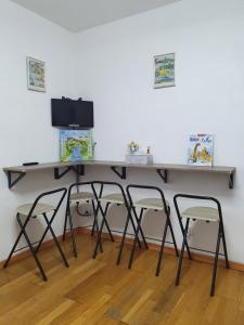 a desk with two chairs and a television at chez christian&astrid Next to Disneyland Paris in Penchard