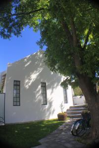 a white building with a tree in front of it at Pecan Tree Cottage in Montagu +16 photos