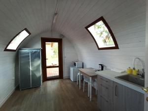 an attic kitchen with a sink and a window at OK - Reka in Zvenigorod