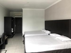 Postel nebo postele na pokoji v ubytování Hotel Sinar 3
