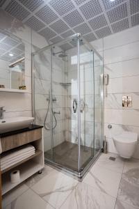 a bathroom with a glass shower and a toilet at Anadolu Hotels Didim Club - Ultra All Inclusive ex Palmwings in Didim