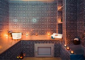 a bathroom with christmas lights on a wall at Riad Des Nations in Marrakesh
