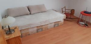 a living room with a couch and a red chair at Holiday Home Lipno Frymburk in Frymburk