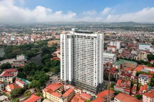 an aerial view of a tall white building at Mandala Hotel & Suites Bac Giang in Bắc Giang